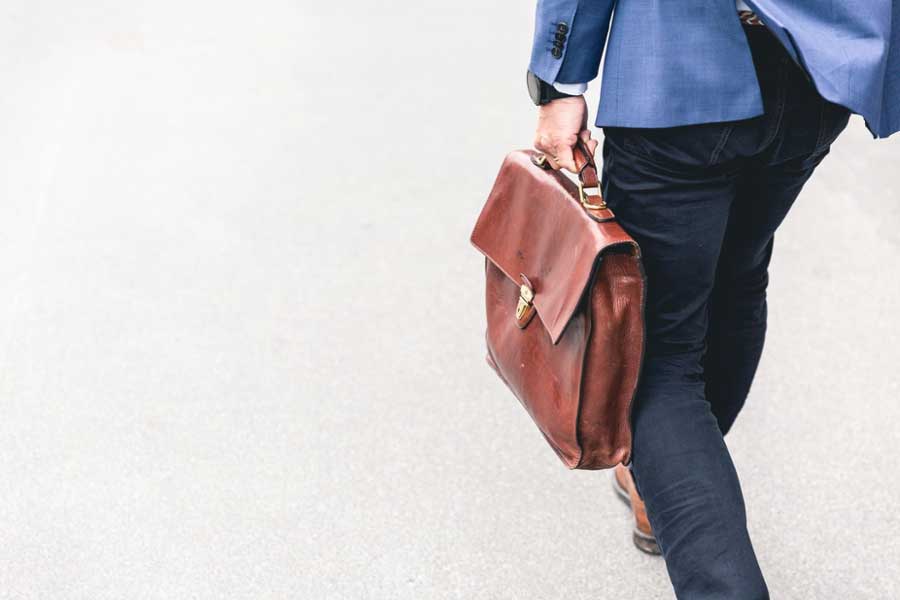 Man walking holding briefcase.