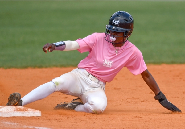 MGA Knights softball player sliding on a base.