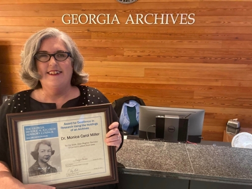 Dr. Monica Miller holds the 2022 Excellence in the Use of Archival Records award.