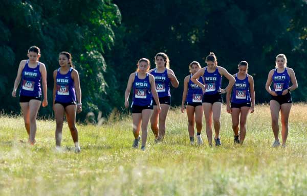 MGA Knights cross-country team walking on the Macon Campus course.