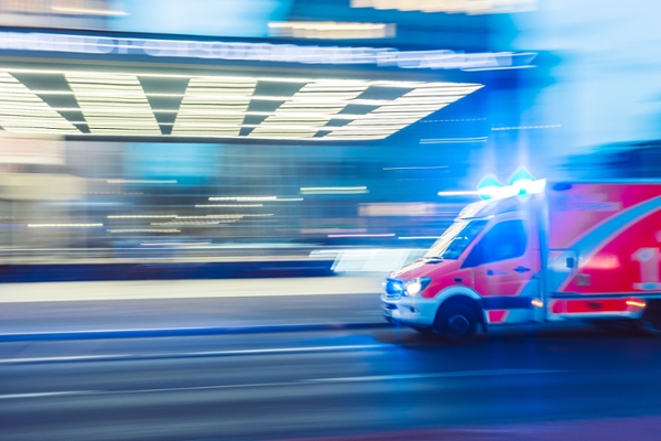 Blurred ambulance driving fast on a street. 