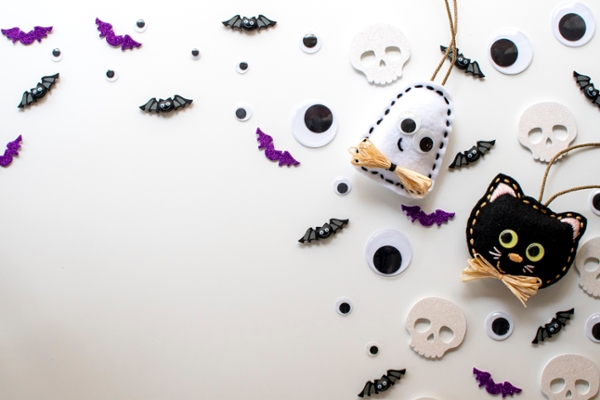 Flat lay of Halloween decorations - cats, ghosts, and bats.