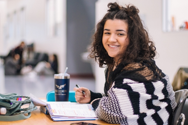 Female student smiling while studying. 