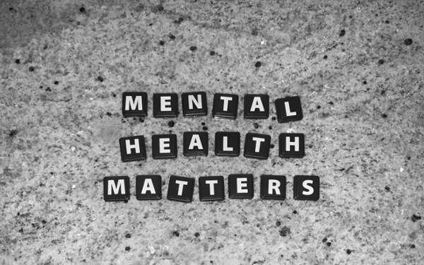 Scrabble tiles on a counter spelling out "mental health matters."