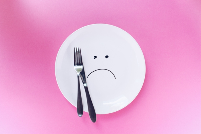 Empty plate with frowning face on it.