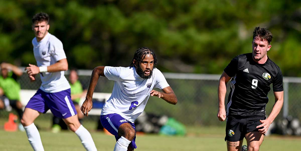 MGA Knights men's soccer team running the field during a match. 