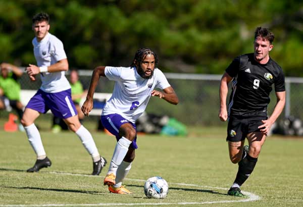 MGA Knights men's soccer team running the field during a match. 