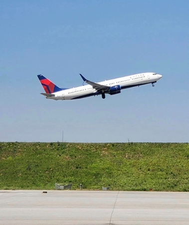 Plane taking off at Delta TechOps. 