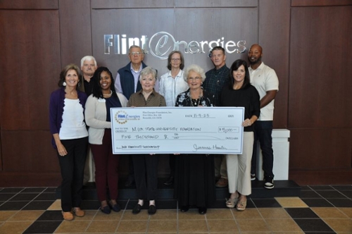 MGA Foundation and Flint Energies Foundation representatives holding a large check. 