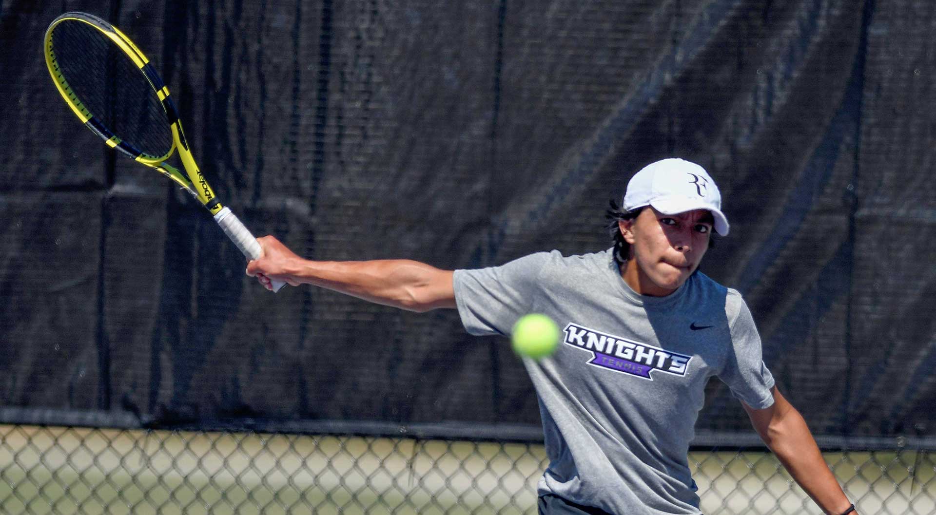 MGA Knights men's tennis player competing in a match. 