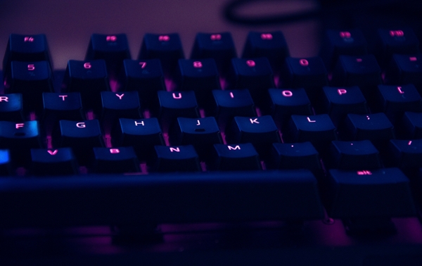 Keyboard backlit in purple LED lights. 
