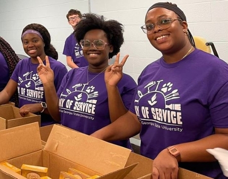 Knights pose for a photo while packing boxes during MGA's 2022 Day of Service.