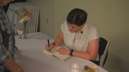Clapsaddle signing copies of her novel.