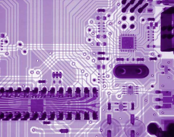 Close up photo of a computer circuit tinted purple.