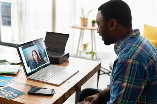 Man having a virtual meeting on his laptop.