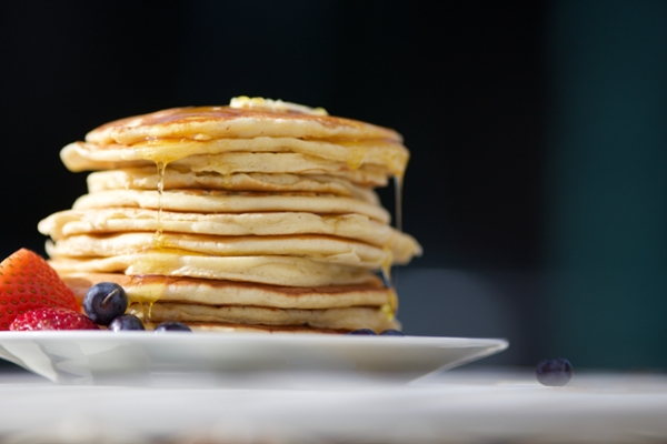 Stack of pancakes and fruit. 
