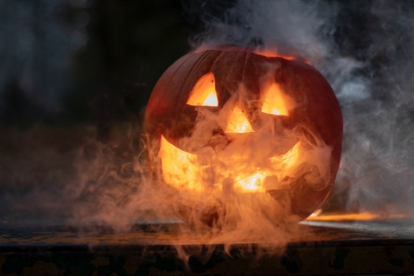 Jack-O-lantern with white smoke oozing from it's eyes and mouth.