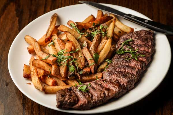 Steak and fries served on a plate. 