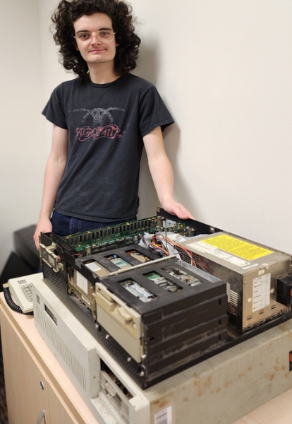 Ryan Ashford poses with the IBM PC-ATs.