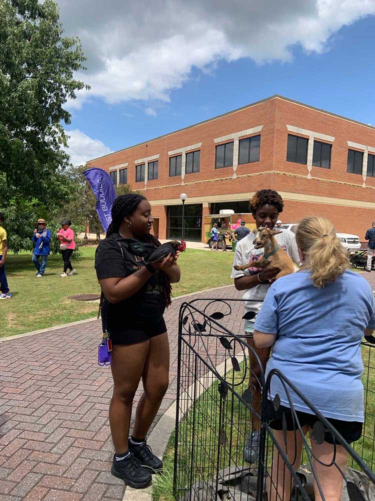 MGA students hold animals at the first Middle Georgia Best Buddies Friendship Walk.