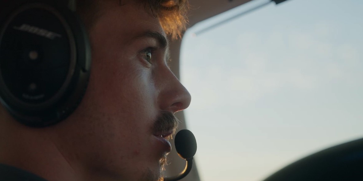 Male MGA aviation student piloting a plane.