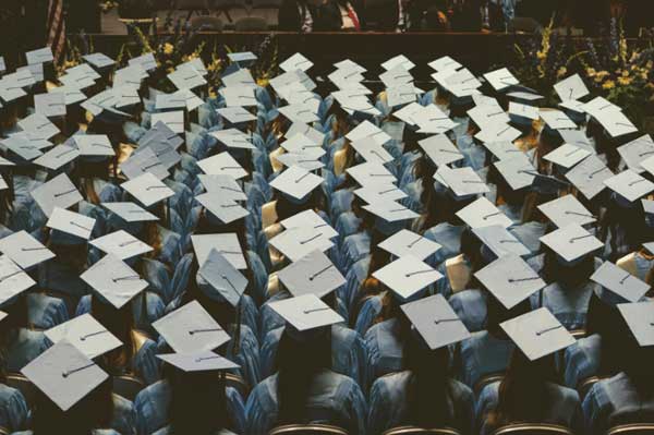 Aerial photo of graduates seated at a graduation ceremony. 