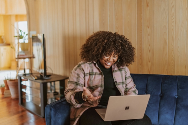Woman smiling at her laptop. 