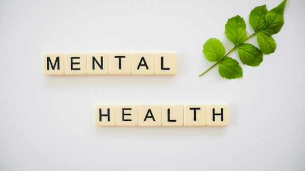 Scrabble letters that spell out "mental health." 