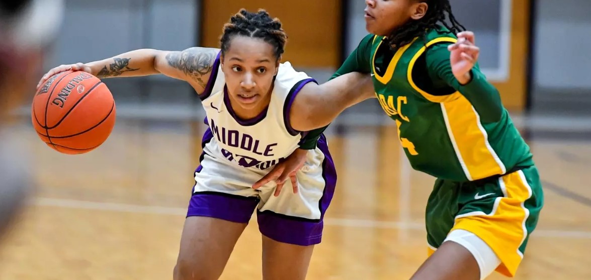 Knights women's basketball player dribbling the ball on the court during a game. 