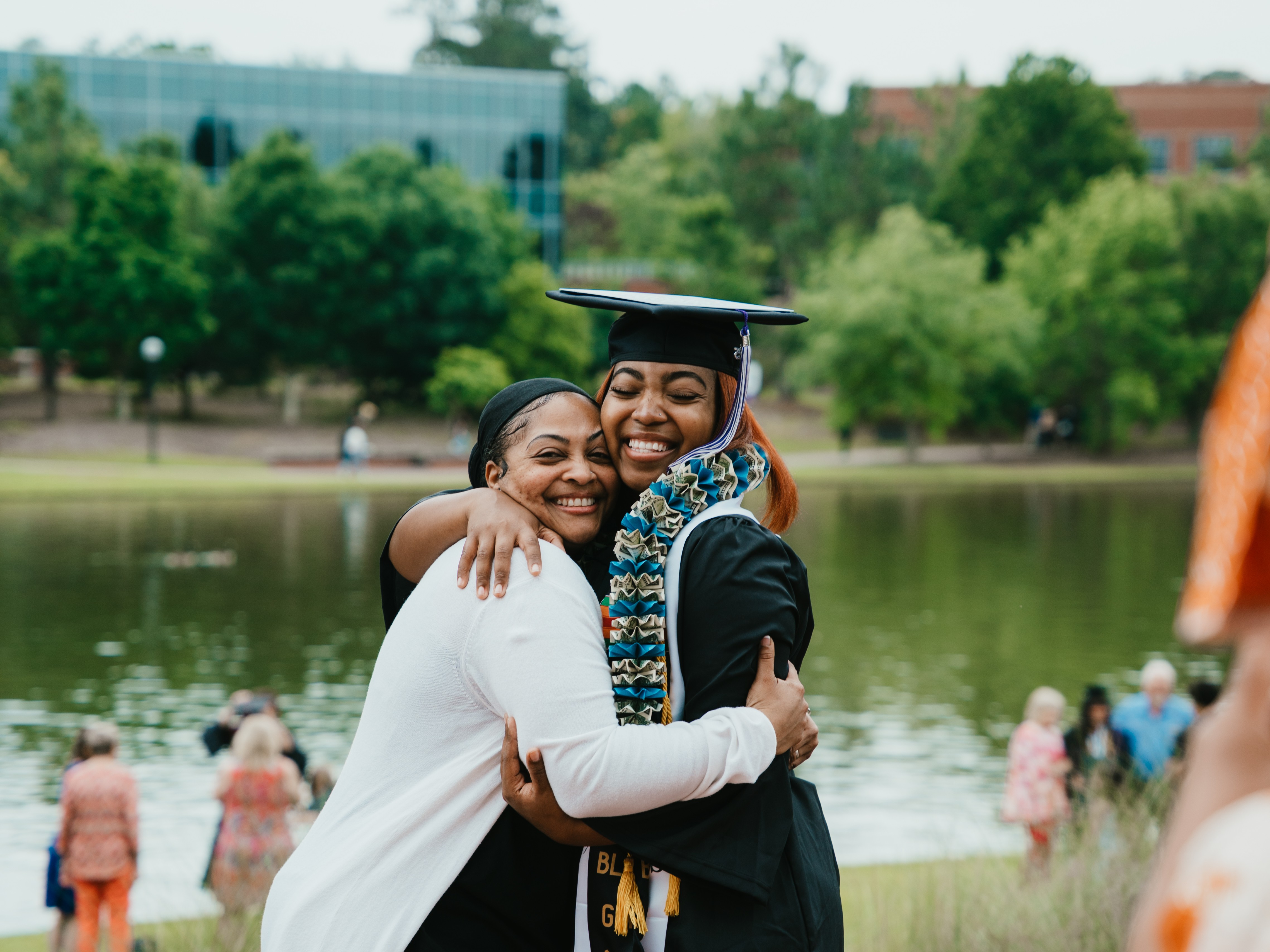 MGA grad poses for a photo with a family member at 2025 spring commencement.