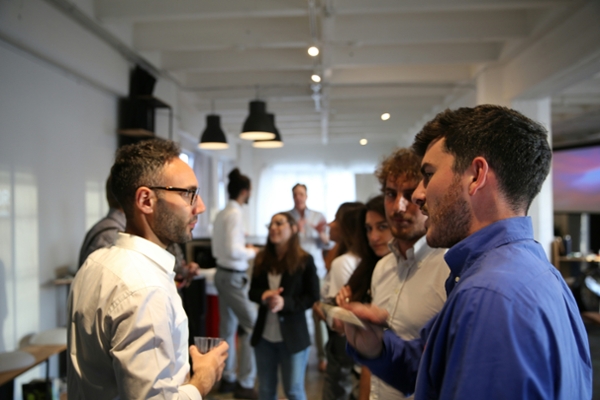 People standing and talking in a room.