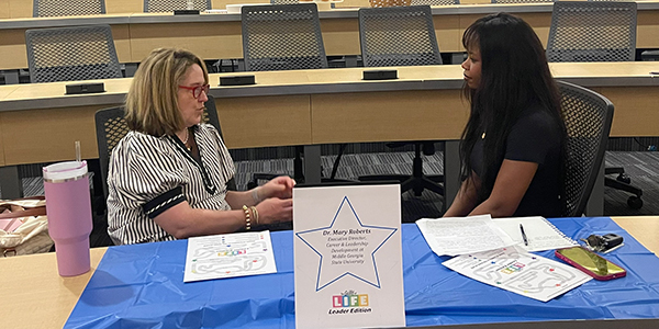 Health Sciences Leadership student interviewing Dr. Mary Roberts.