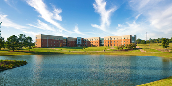 Wide shot image of MGA's Lakeview Pointe dorm hall on the Macon Campus during a sunset.