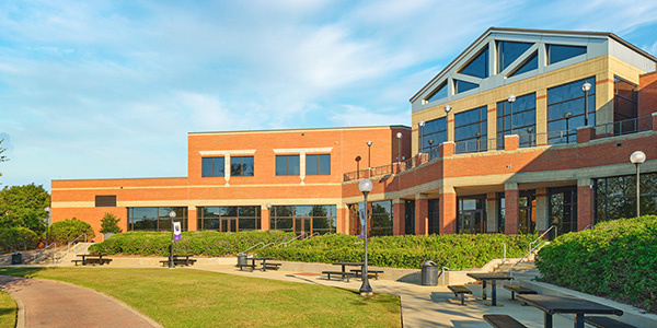 Wide shot of the Student Life Center at MGA's Macon Campus on a bright, sunny day.