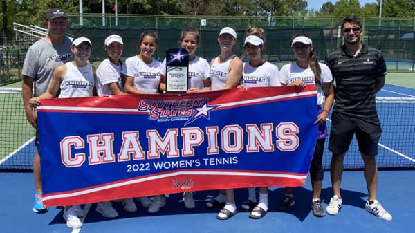 MGA Knights women's tennis team holding their trophy and banner from their SSAC championship win. 