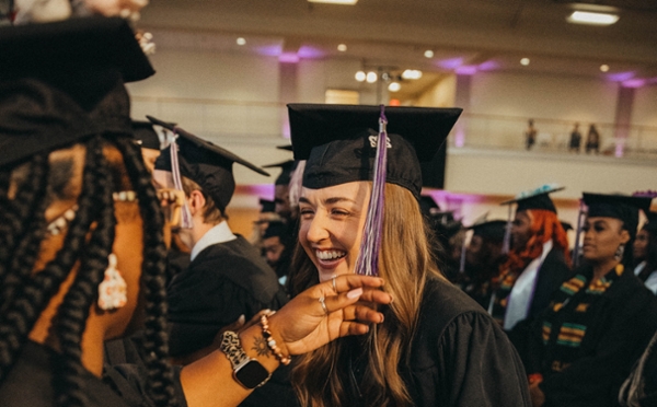 Spring 2022 graduate smiling after her tassel is turned.