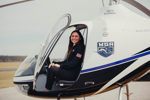 Female aviation student in a helicopter.