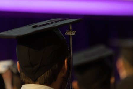 Close up shot of a 2022 graduation cap upon a student's head. 
