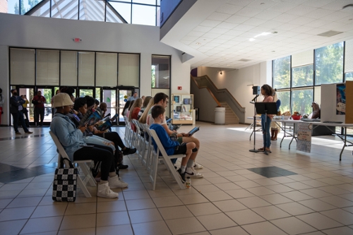 Students reading their published work at the Fall Line Review launch party. 