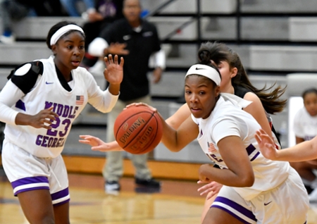Knights women's basketball players on offense during a game. 