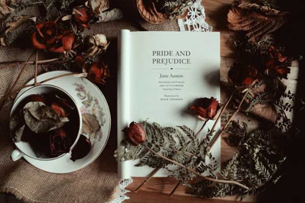 Jane Austen's Pride & prejudice sitting on a table amongst roses