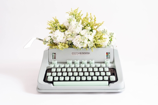 Typewriter with flowers sprouting from the top.