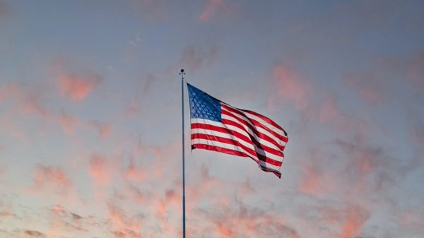 American flag flying at sunset. 