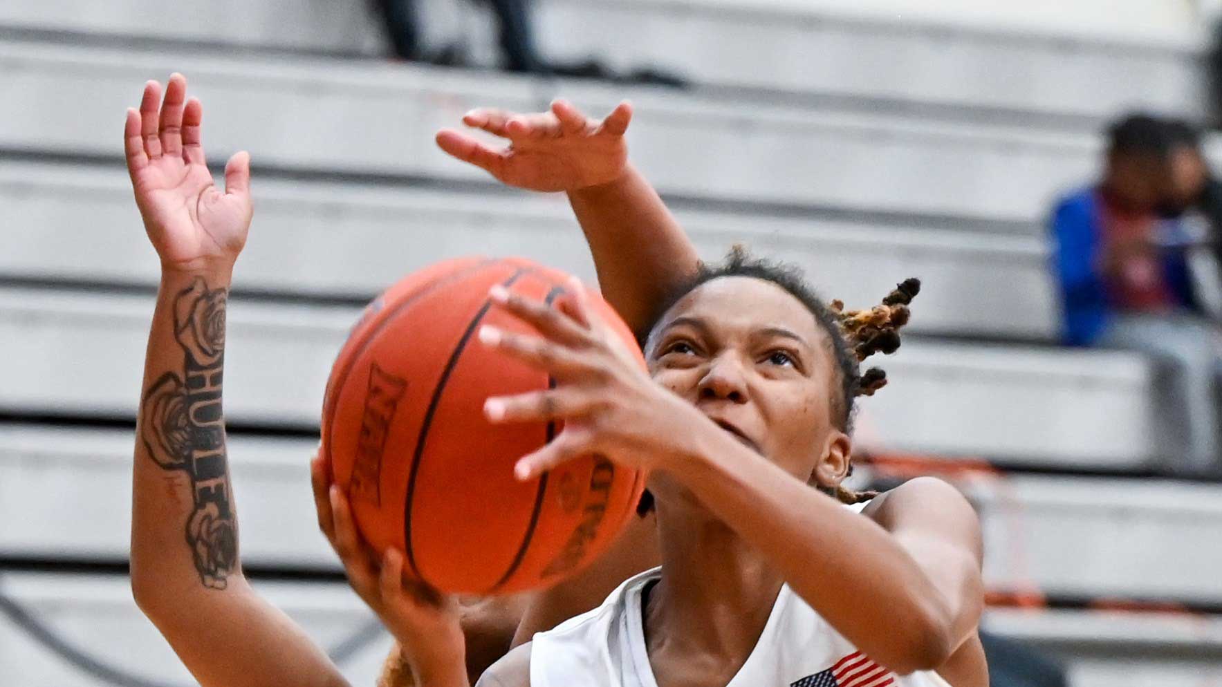 Close up shot of a knights women's basketball player during a layup.