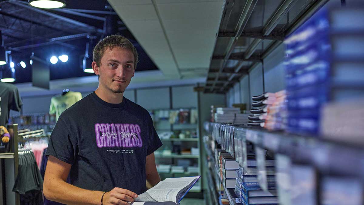 Student browsing textbooks in the Cochran Campus bookstore.
