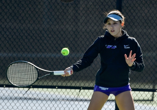 MGA Knights women's tennis player hitting the ball during a game.
