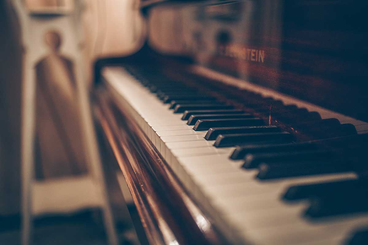 Close up photo of aged piano keys. 