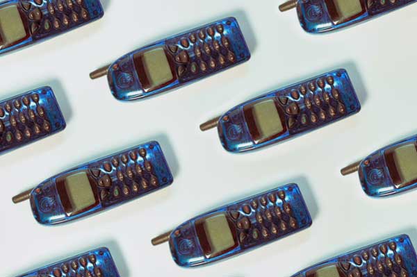 Flatlay of blue vintage cell phones. 