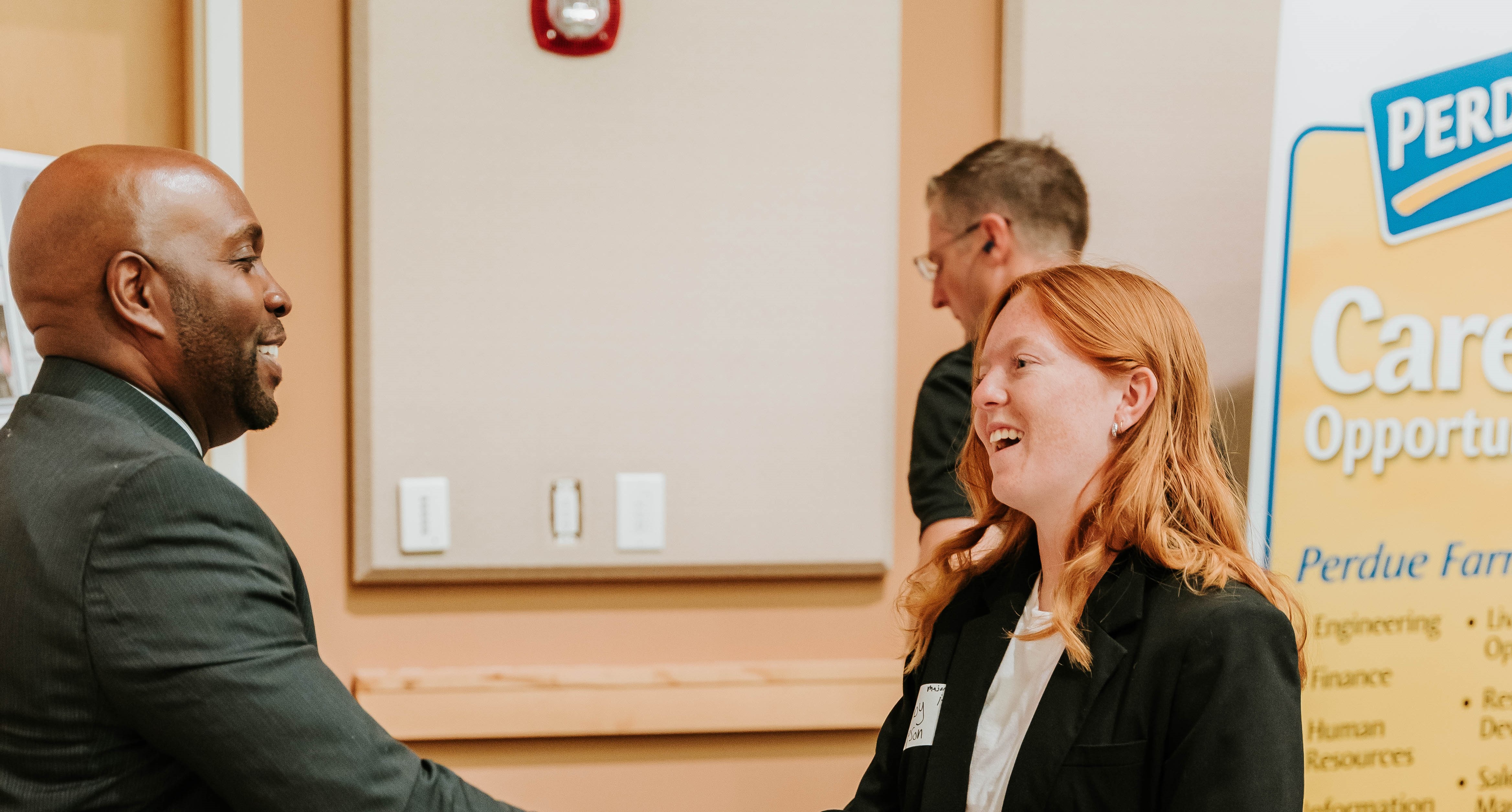 Man and woman shake hands at MGA's Fall 2023 Career Fair.