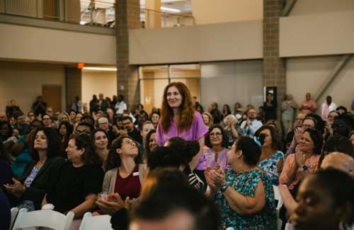 Professor Weignier stands and receives applause at 2024 Convocation.